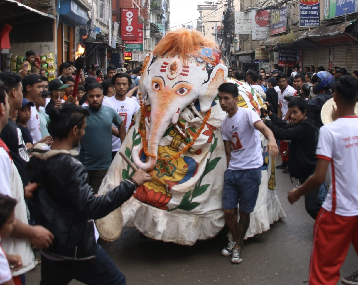 Pulu Kisi, the white elephant, moves through the crowd